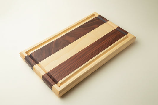 Wooden cutting board with striped pattern on a round black table